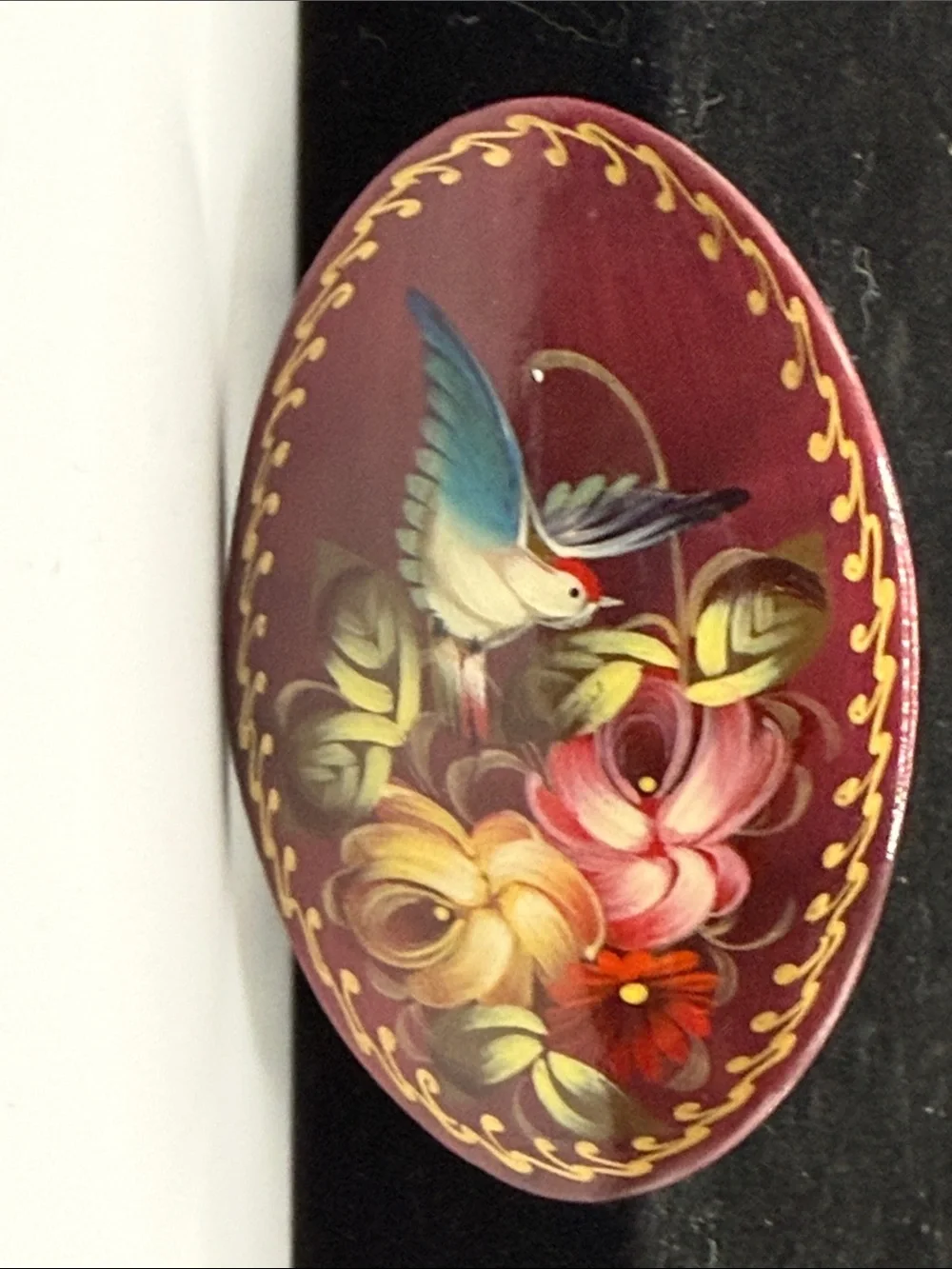 vintage Russian hand-painted lacquered wood brooch featuring a hummingbird among